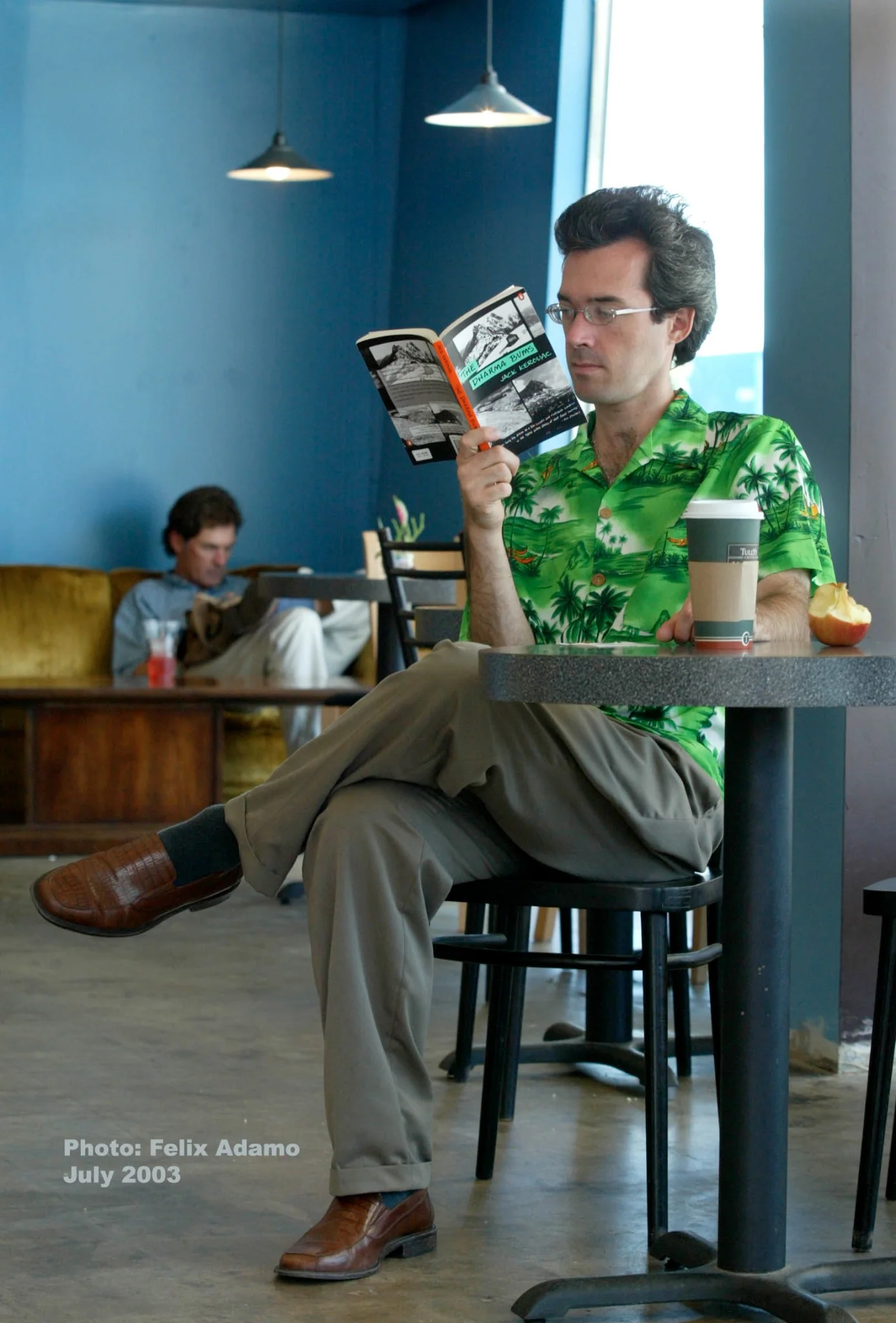 A customer reading beside a cup of coffee at Dagny's in 2003