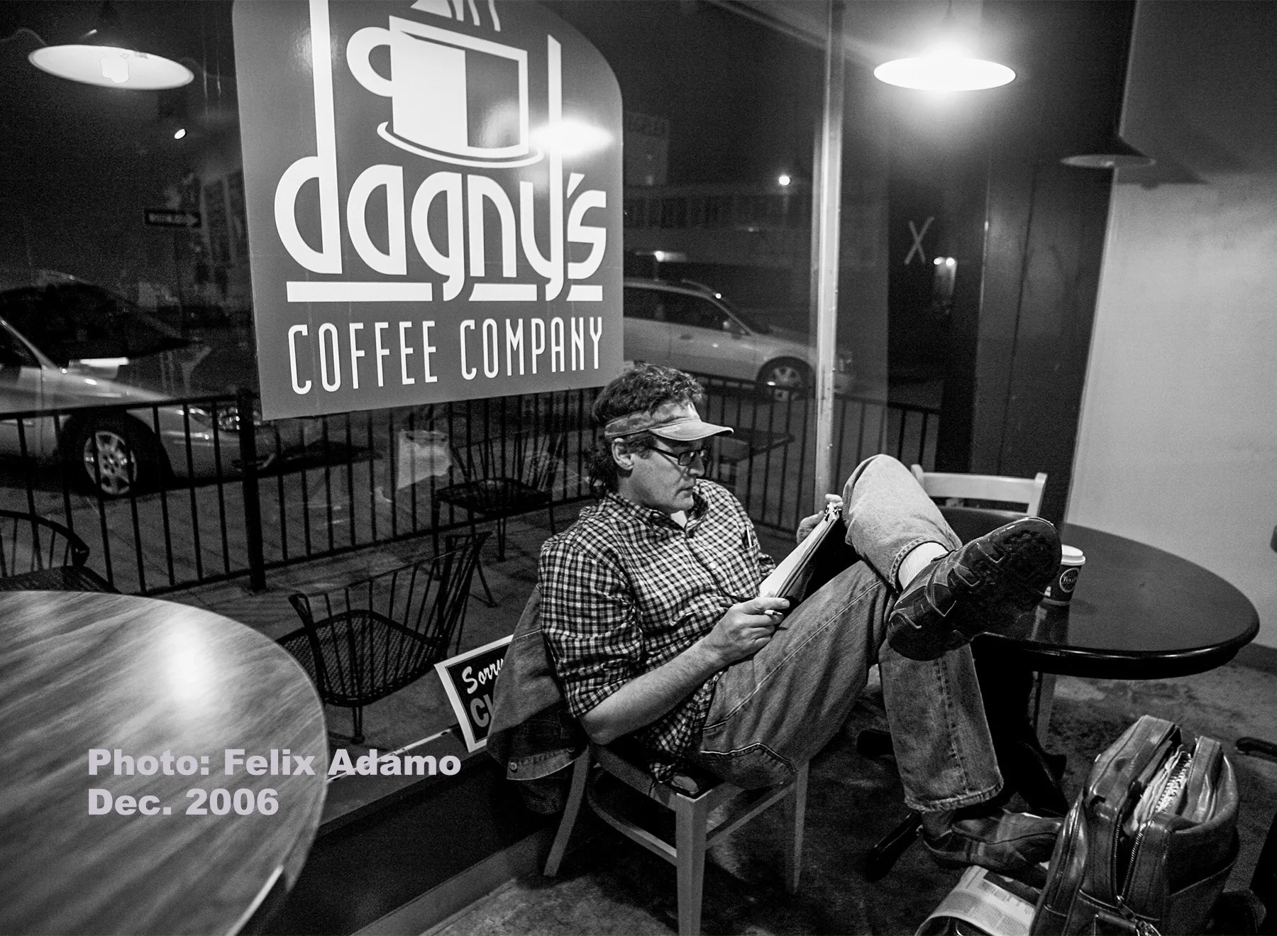 A customer reading by the front window at night at Dagny's in 2006