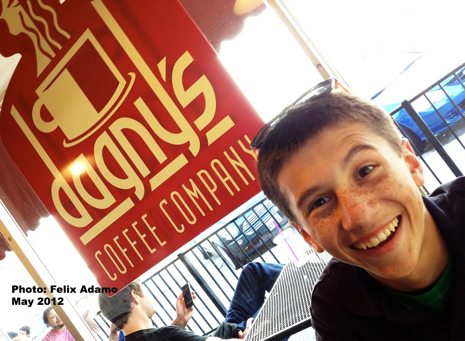 A smiling customer posing beside the Dagny's sign in 2012